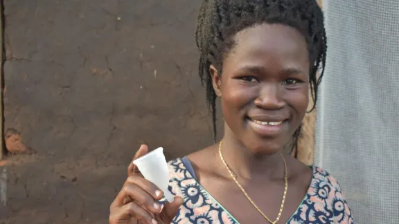Nighty Ayot shows off the menstrual cup she received from LWF