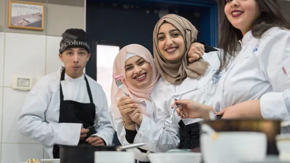 Students enjoy the food they have prepared during catering class at the vocational training centre in Beit Hanina