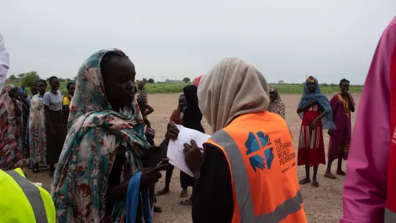 Ajook Awer, LWF South Sudan case worker, is registering adolescent girls escaping from Sudan conflict.